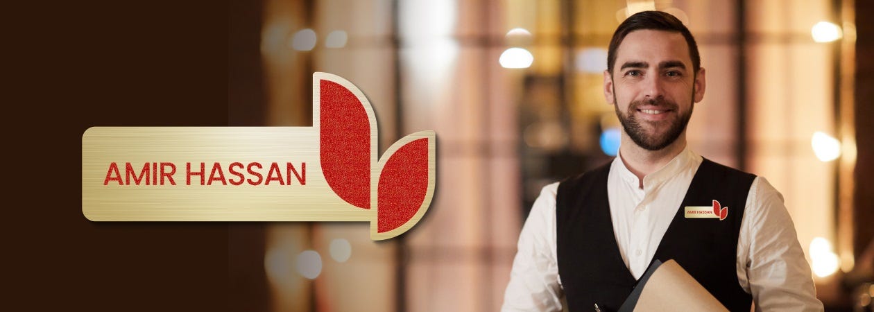 Amir Hassan, a smiling man in a suit, stands proudly as the new face of the hotel industry.