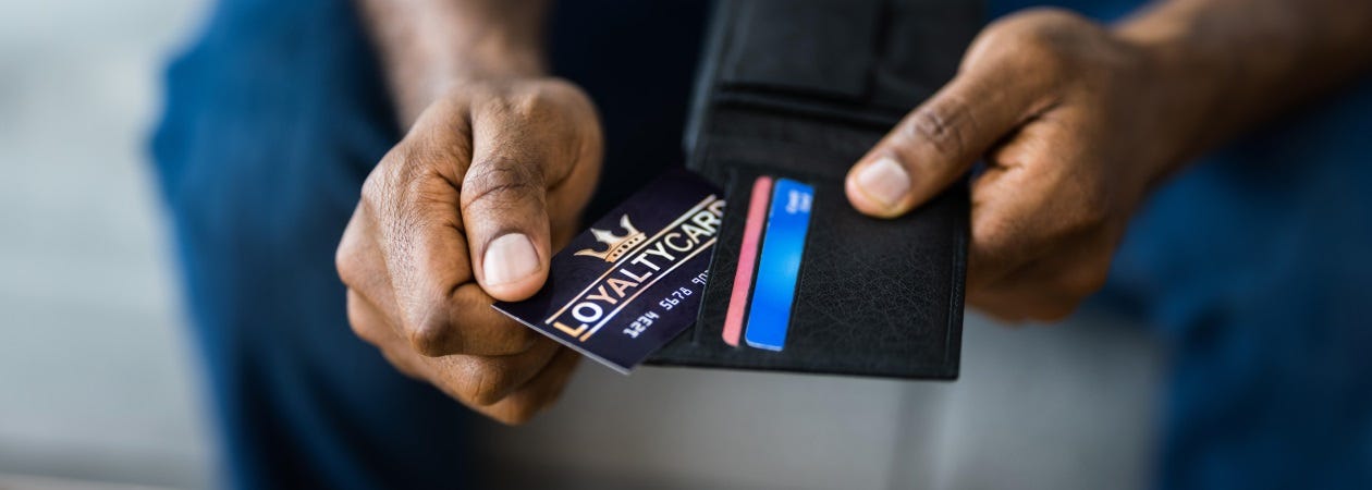 A man holding his Membership Program card