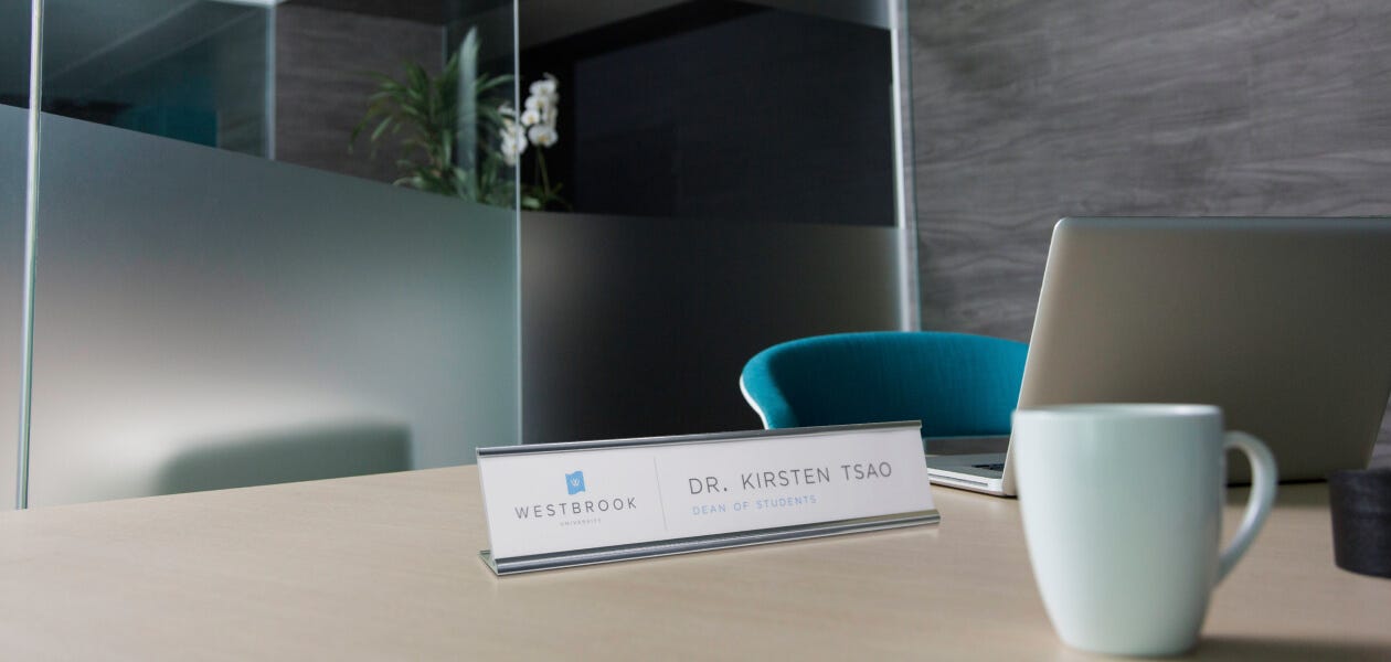 Desktop name plate with a sleek design and personalized text. Perfect for adding a professional touch to your workspace.
