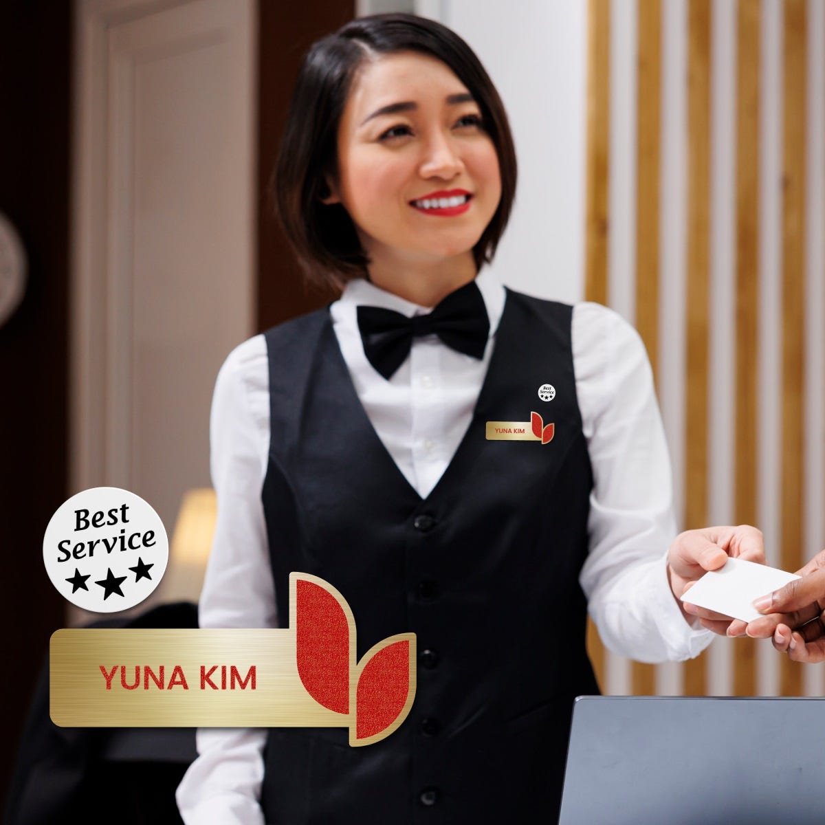 A woman wearing name badge handing a card to a man