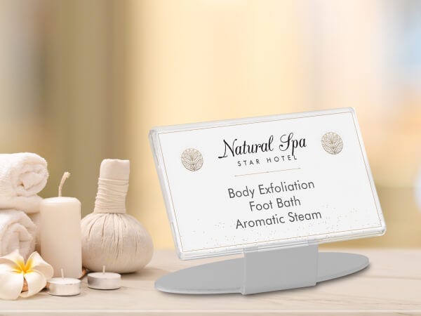 A reusable standing sign advertising a natural spa body massage.